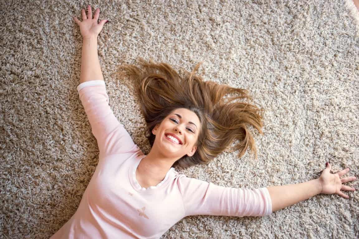 Woman laying on brand new carpet