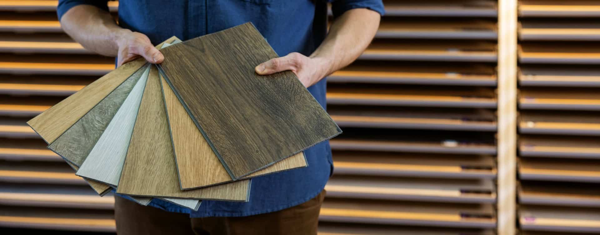 Man holding selection of flooring samples