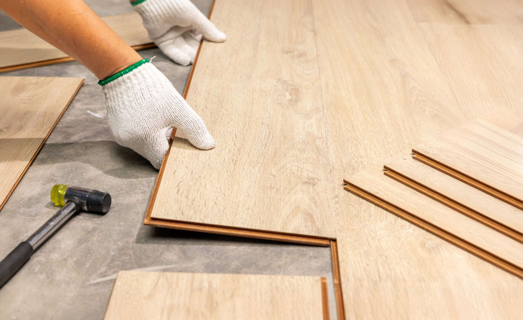 Worker installing new laminate flooring
